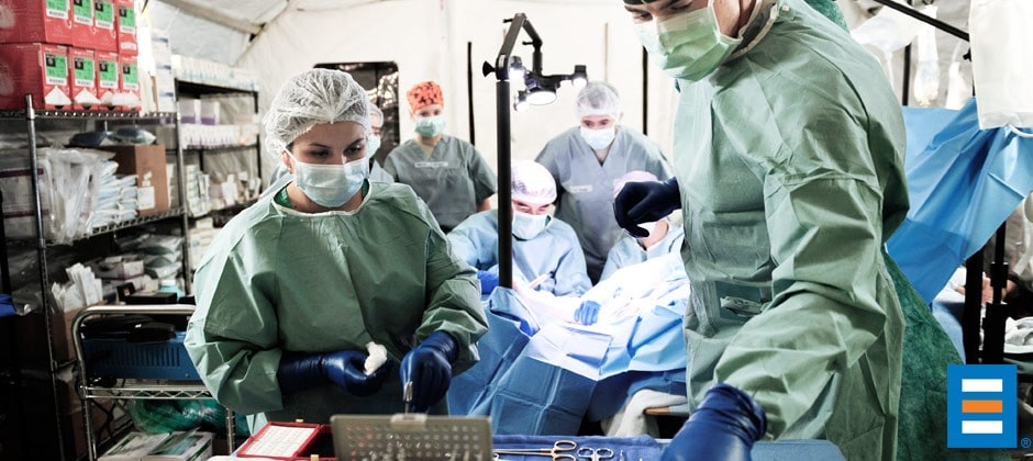Doctors perform emergency surgery in a BLU-MED Mobile Field Hospital.