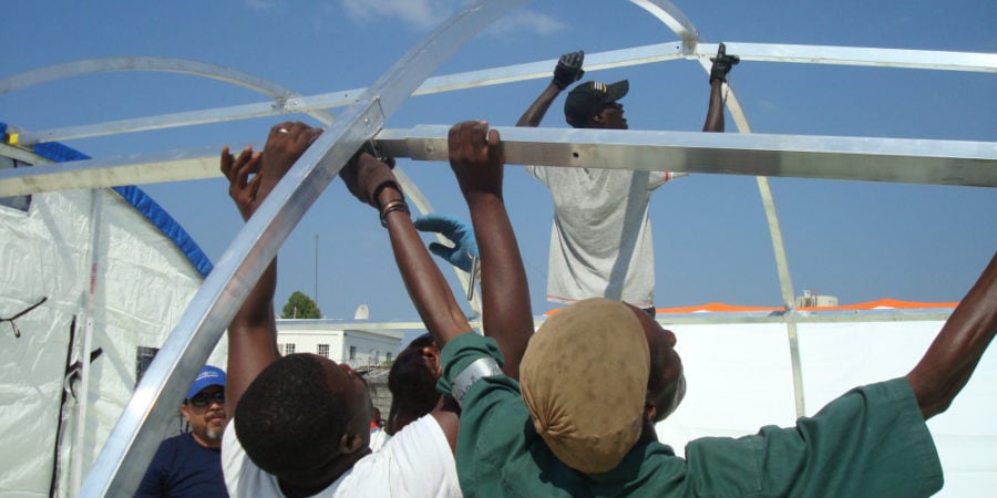 People setting up a Mobile hospital building in Haiti post Earthquake