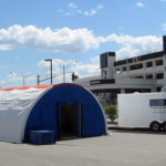 A BLU-MED Mobile Field Hospital and RapidSurge trailer deployed outside of a medical center.