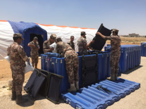 Jordanian soldiers unpack components of a 50-bed BLU-MED Field Hospital that was rapidly shipped in a low-cube, roto-mold shipping container. 