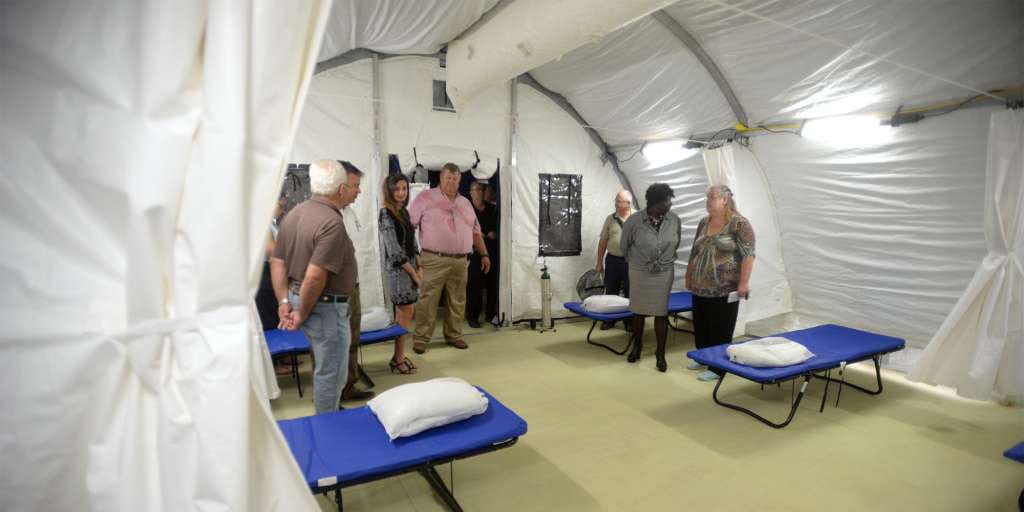 Planning team inside portable hospital tents after Hurricane Harvey in Port Arthur, TX