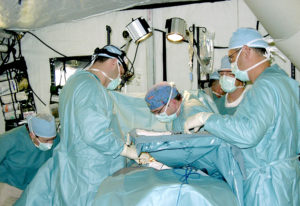 Doctors perform emergency surgery in a BLU-MED Mobile Field Hospital's operating room.